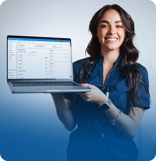 Dentista sorrindo segurando um notebook com o Simples Dental aberto